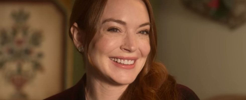 Lindsay Lohan smiling in the Falling For Christmas trailer.
