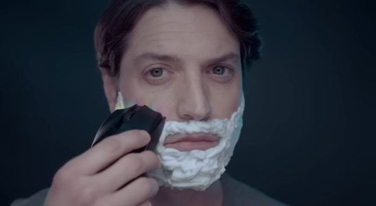 Close up of man shaving his face with a Razer mouse