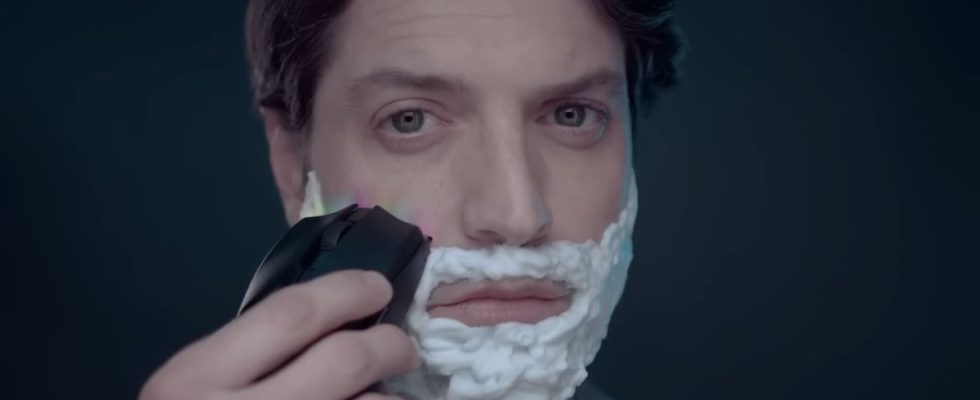 Close up of man shaving his face with a Razer mouse