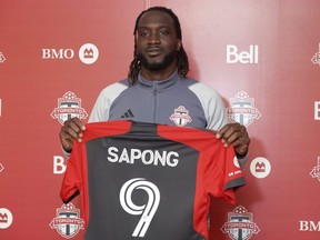 L'attaquant nouvellement acquis du Toronto FC CJ Sapong montre son chandail le vendredi 28 avril 2023 au centre d'entraînement du club de la MLS, à Toronto.