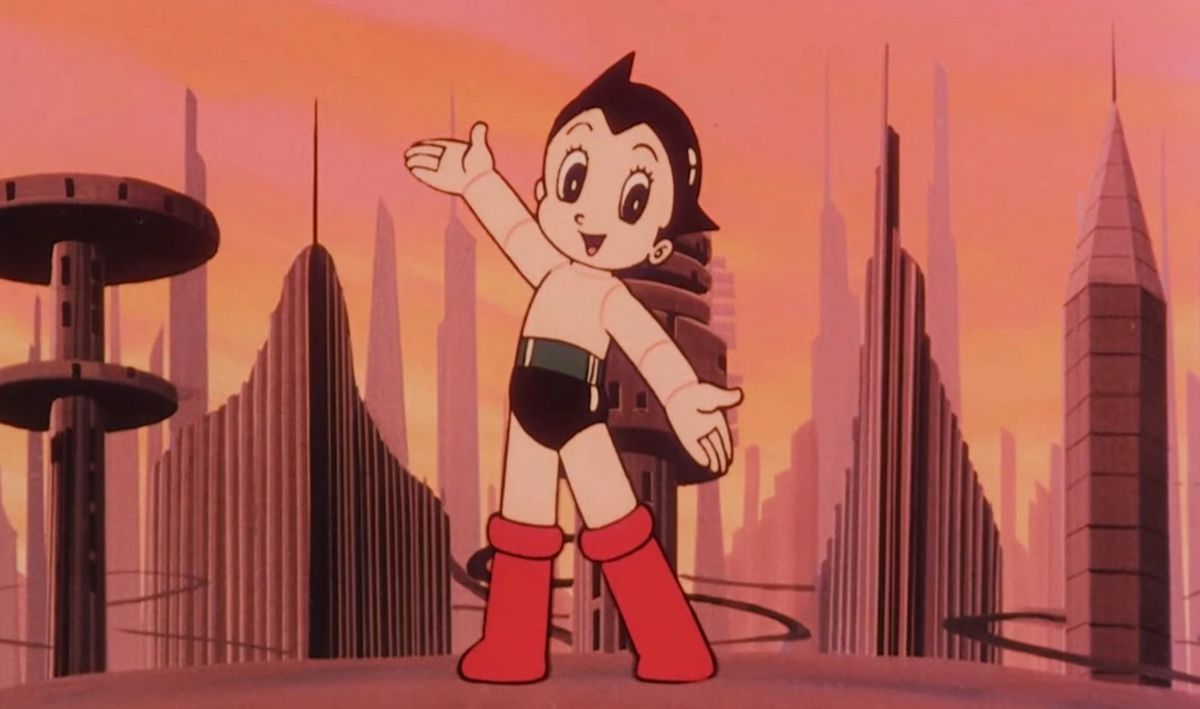 Une capture d'écran colorée du dessin animé Astro Boy de 1980, montrant Astro Boy debout sur un rebord surplombant une ville futuriste.