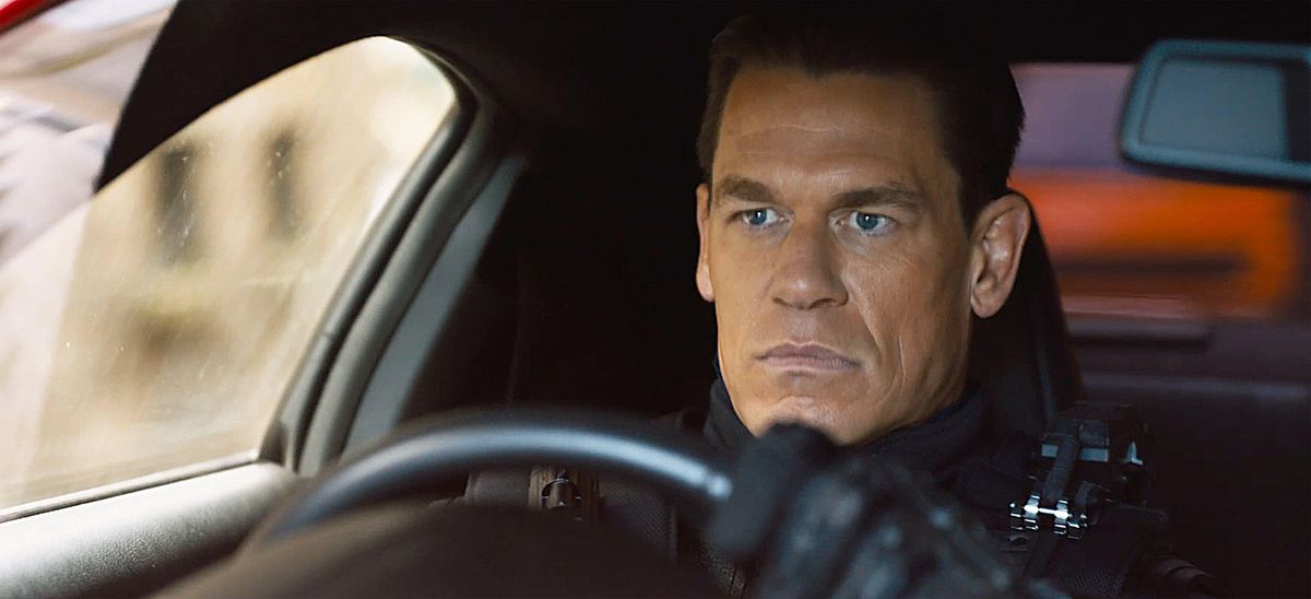 Jakob (John Cena, dans un tas de poudre bronzante étonnamment orange qu'il ne porte pas dans le dernier film) est assis d'un air maussade dans une voiture en F9