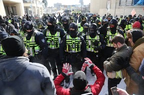 L'une des nombreuses lignes de police où les manifestants et la police se sont affrontés le 18 février 2022, lors de la manifestation du Freedom Convoy au centre-ville d'Ottawa.  (JEAN LEVAC/Ottawa Citizen)