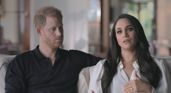 Prince Harry looking at Meghan Markle while she talks to the camera in Harry & Meghan.