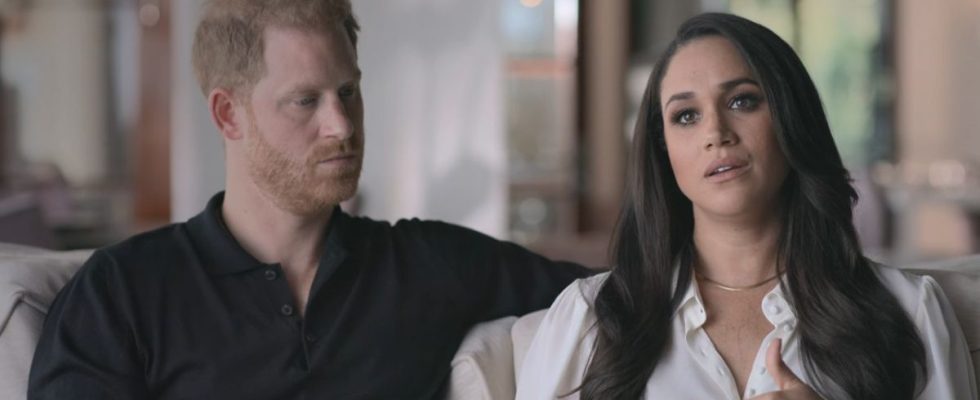 Prince Harry looking at Meghan Markle while she talks to the camera in Harry & Meghan.