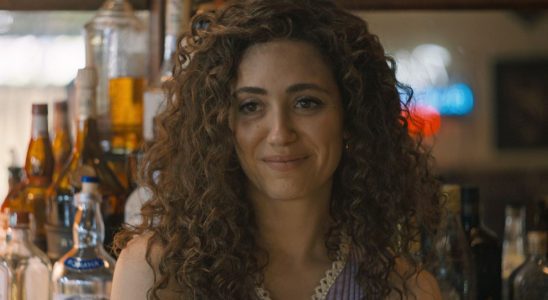 Emmy Rossum standing behind a bar in The Crowded Room.