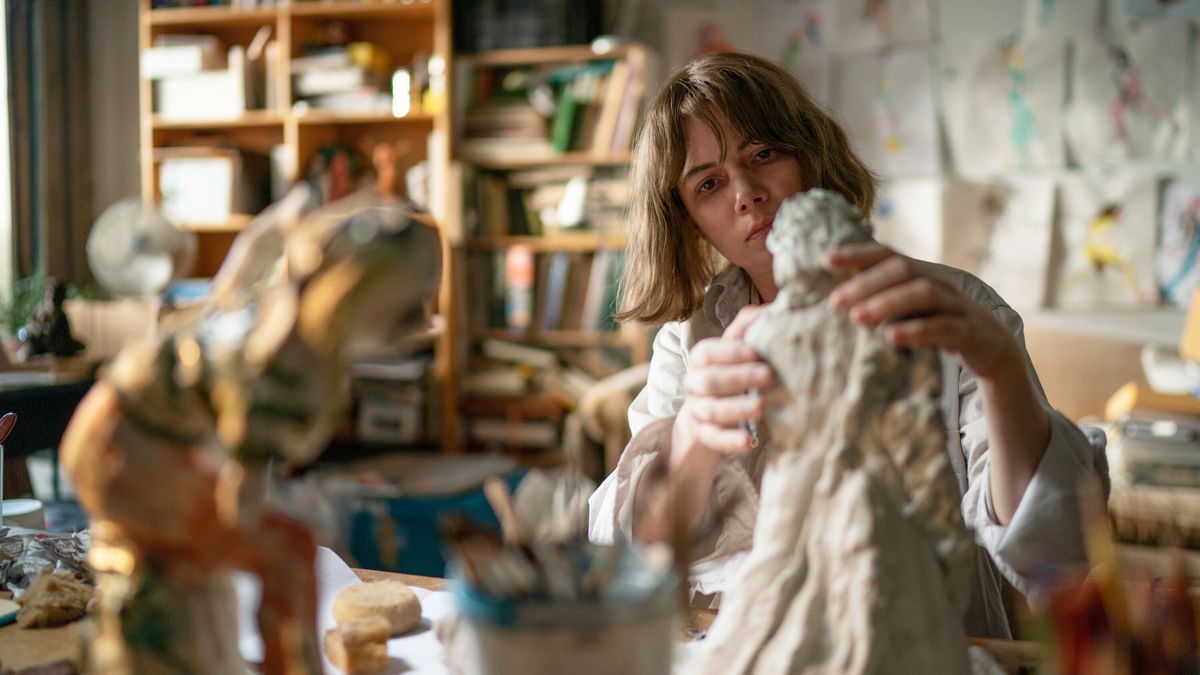 Michelle Williams moule une sculpture dans un studio d'art dans Showing Up.