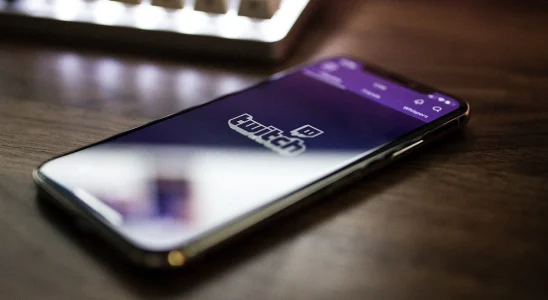 A mobile phone with the Twitch logo on it.
