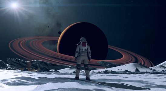 An explorer from Starfield stands in front of a saturn-esque ringed planet, looming on the horizon.