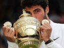 Carlos Alcaraz embrasse le trophée du vainqueur après avoir battu Novak Djokovic lors de la finale de Wimbledon au All England Tennis Club de Wimbledon le 16 juillet 2023. 