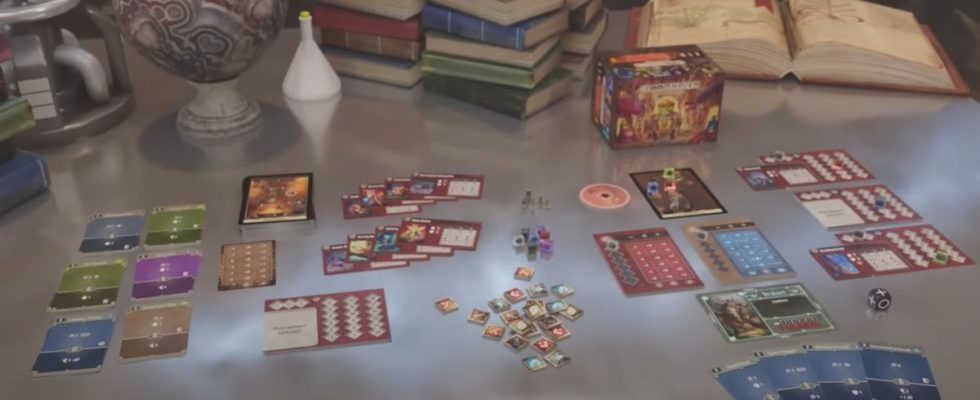 Gloomhaven: Buttons & Bugs components laid out on a table, with science equipment around it