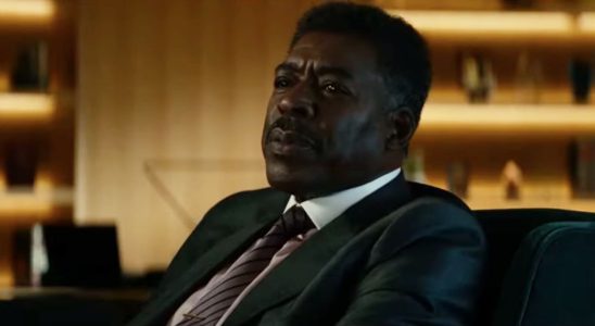 Ernie Hudson sits at his desk while telling a story in Ghostbusters: Afterlife.