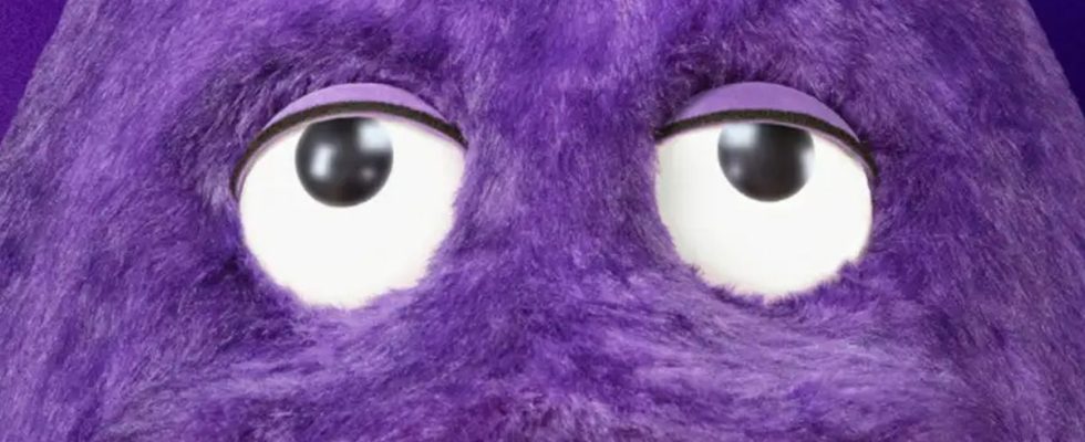 Grimace, a big purple mascot from McDonalds, looks up at something off-screen.