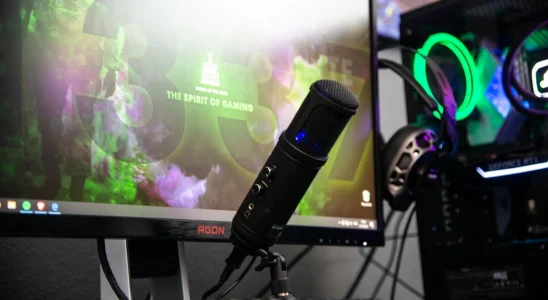 A streaming microphone set up in front of a monitor.