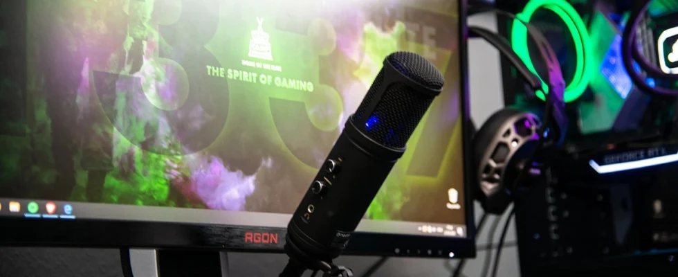 A streaming microphone set up in front of a monitor.