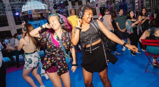 Concert goers dancing at the Silent Disco dance party at Lincoln Center, New York City on Saturday, July 1, 2023.