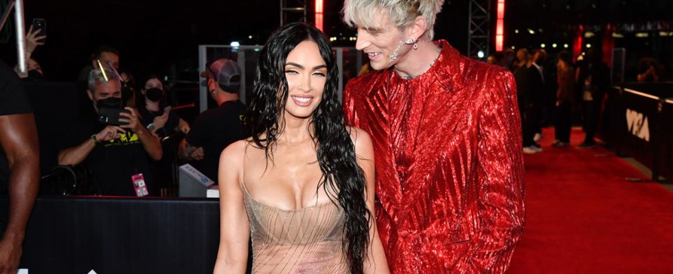 Megan Fox in naked dress at VMAs with Machine Gun Kelly in a red suit.