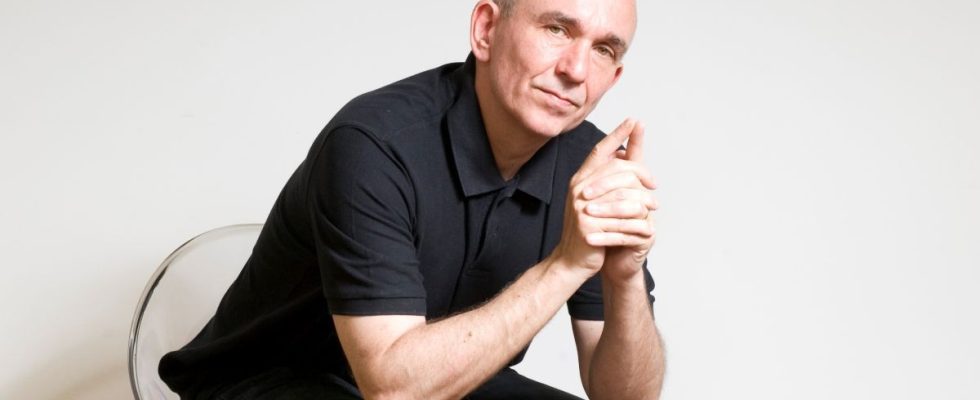 Peter Molyneux in a chair.