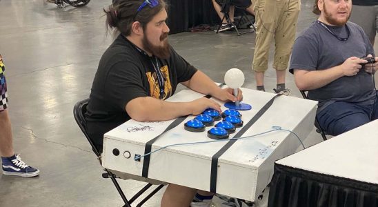 An EVO 2023 attendee with a massively oversized fightstick.
