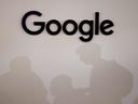 Les ombres des visiteurs à côté du logo Google Inc. lors du salon des startups technologiques et de l'innovation Vivatech à Paris.