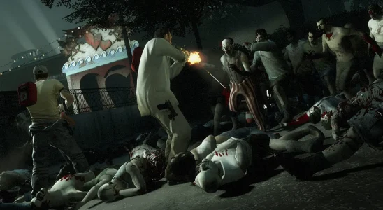 Left 4 Dead 2: Nick and Ellis fighting off a horde of zombies at a carnival.