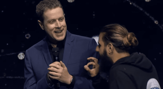 A stagecrasher approaches Geoff Keighley on stage early in Gamescom Opening Night Live 2023.