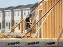 Un ouvrier du bâtiment construit une nouvelle maison à London, en Ontario.