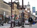 Un homme marche dans le centre-ville de Peterborough, en Ontario.