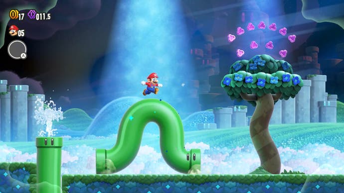 Une capture d'écran de Super Mario Bros. Wonder montrant Mario sur un tuyau vert frétillant.