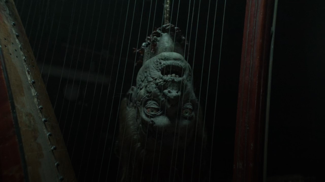 Tête de Walker jouant de la harpe dans The Walking Dead : Daryl Dixon