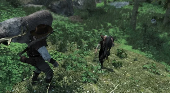 Skyrim: Two characters carrying dead animals on their shoulders.
