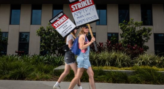 Hollywood, CA - July 31: Someone carried a sign that asked, "AMPTP?? More Like AMPTP-POO!!," while joining members of the Writers Guild of America (WGA),  members of the Screen Actors Guild (SAG) and American Federation of Television and Radio Artists (AFTRA), to picket in front of Netflix headquarters, in Hollywood, CA, Monday, July 31, 2023. Entertainment's largest guilds have come together, during disputed contract negotiations with the Alliance of Motion Picture and Television Producers (AMPTP).(Jay L. Clendenin / Los Angeles Times via Getty Images)