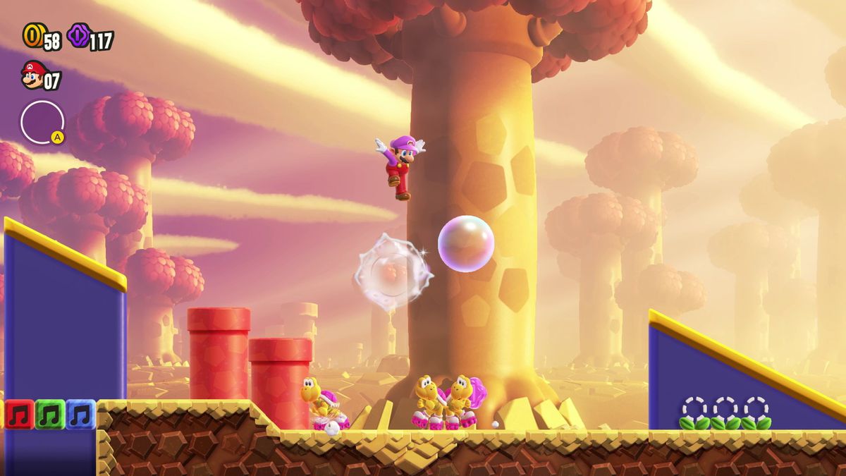 Mario saute sur une bulle au-dessus d'un trio de Koopas en roller dans une capture d'écran de Super Mario Bros. Wonder