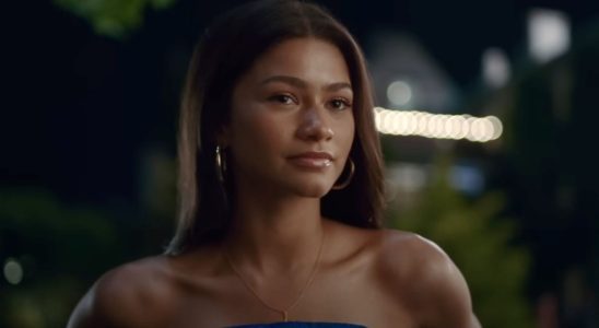 Zendaya looking forward while wearing a strapless blue dress in Challengers.