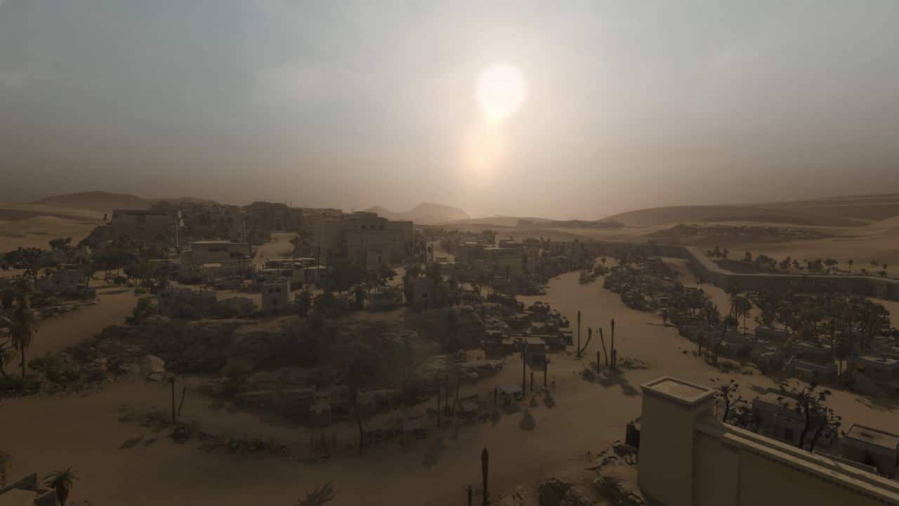Revue de Total War Pharaoh : Un plan large d'une ville fortifiée tentaculaire dans le désert.