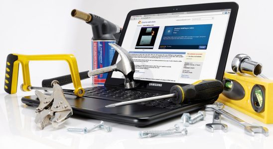 A laptop covered in tools and equipment
