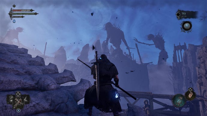 Le joueur regarde une vue bleue remplie de deux énormes squelettes dans Lords Of The Fallen.