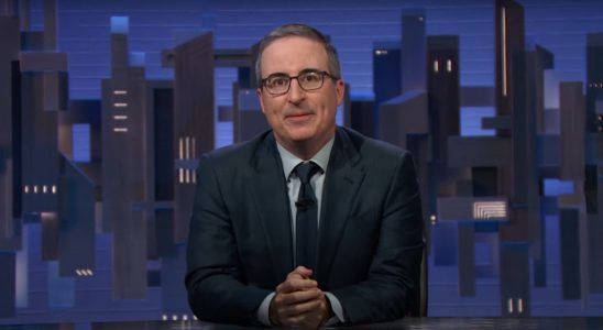 John Oliver sitting at his desk, introducing a segment on Last Week Tonight with John Oliver.