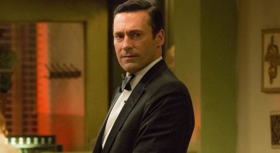 Jon Hamm standing in a tuxedo with a concerned look on his face, in Mad Men.