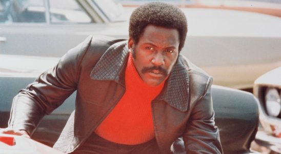 Richard Roundtree, US actor, crouching behind a red sports car in a publicity still issued for the film, 'Shaft', 1971. The blaxploitation film, directed by Gordon Parks (1912-2006), starred Roundtree  as 'John Shaft'. (Photo by Silver Screen Collection/Getty Images)