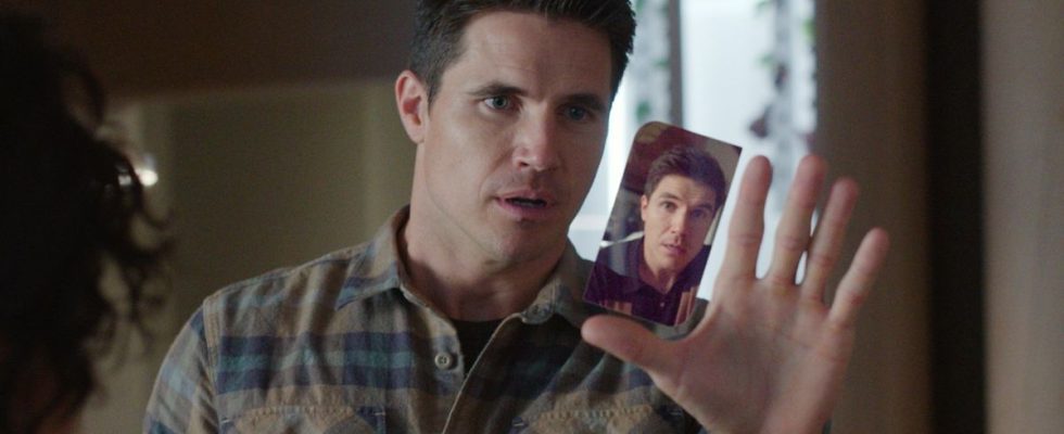 A press image of Robbie Amell as Nathan looking at Nathan on his phone in Upload.