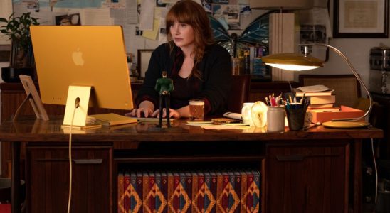 Bryce Dallas Howard working hard at her cluttered desk in Argylle.