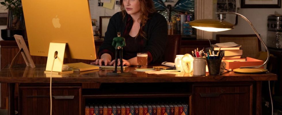 Bryce Dallas Howard working hard at her cluttered desk in Argylle.
