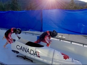 Le freineur Jay Dearborn, à gauche, s'élance au départ d'une course de bobsleigh à deux sur le mont Whistler, en Colombie-Britannique, lors de la Série canadienne de courses d'évaluation en 2020.