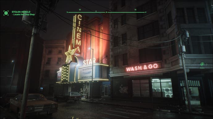 Une capture d'écran de RoboCop : Rogue City, montrant un cinéma et une laverie illuminés la nuit par leurs enseignes au néon.