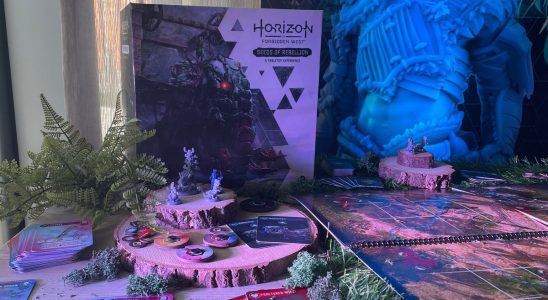 The Horizon Forbidden West: Seeds of Rebellion box, board, miniatures, and tokens on a table filled with wood and fake plants