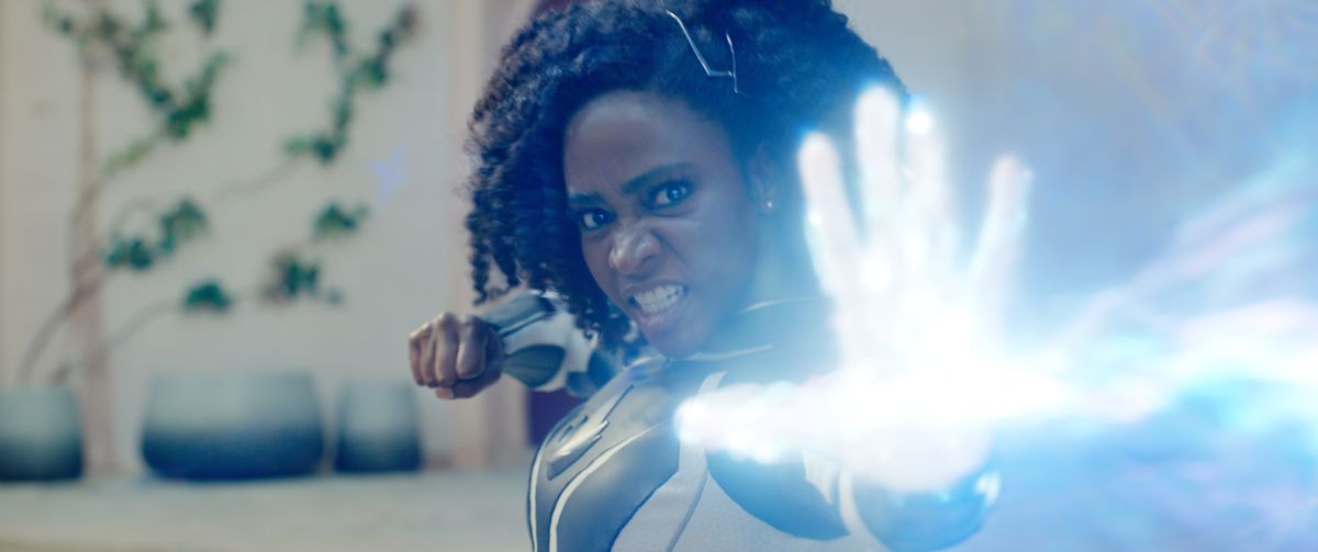 Teyonah Parris dans le rôle du capitaine Monica Rambeau grogne alors qu'elle fait exploser un ennemi hors écran avec une explosion de lumière blanche et brillante dans le film Marvel Cinematic Universe The Marvels