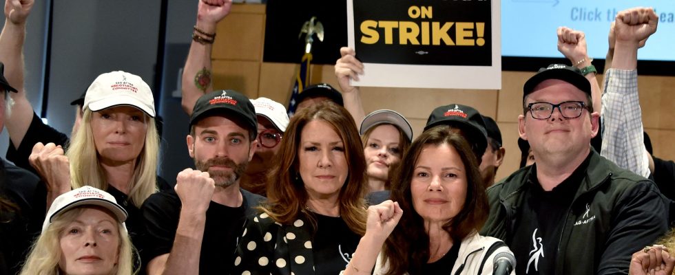 TOPSHOT - US actress Frances Fisher, SAG-AFTRA secretary-treasurer US actress Joely Fisher, SAG-AFTRA President US actress Fran Drescher, and National Executive Director and Chief Negotiator Duncan Crabtree-Ireland, joined by SAG-AFTRA members, pose for a photo during a press conference at the labor union's headquarters in Los Angeles, California, on July 13, 2023. Tens of thousands of Hollywood actors will go on strike at midnight Thursday, effectively bringing the giant movie and television business to a halt as they join writers in the first industry-wide walkout for 63 years. The Screen Actors Guild (SAG-AFTRA) issued a strike order after last-ditch talks with studios on their demands over dwindling pay and the threat posed by artificial intelligence ended without a deal. (Photo by Chris Delmas / AFP) (Photo by CHRIS DELMAS/AFP via Getty Images)