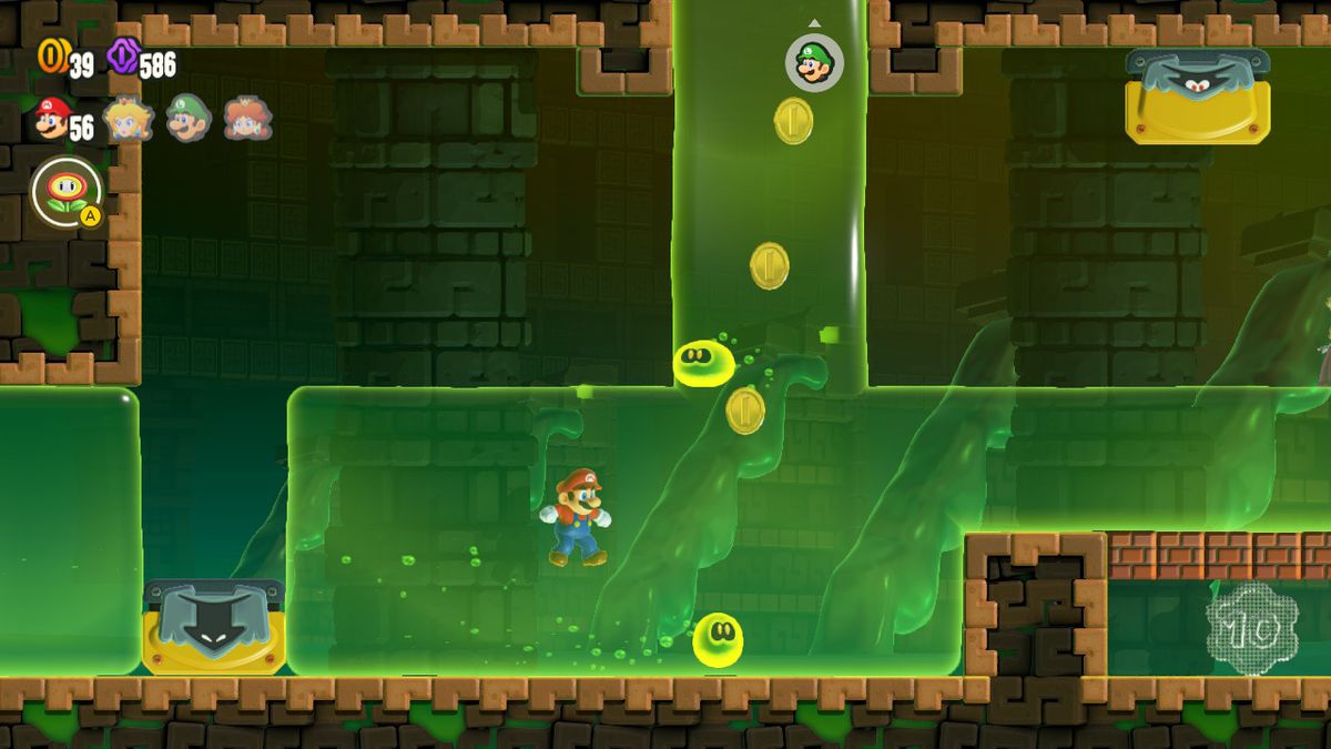 Mario nage dans le slime, flanqué de Wubbas, dans une capture d'écran de Super Mario Bros. Wonder