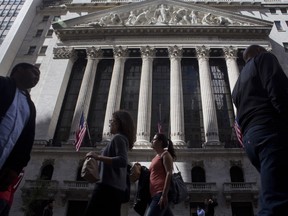Les piétons passent devant la Bourse de New York à New York, aux États-Unis